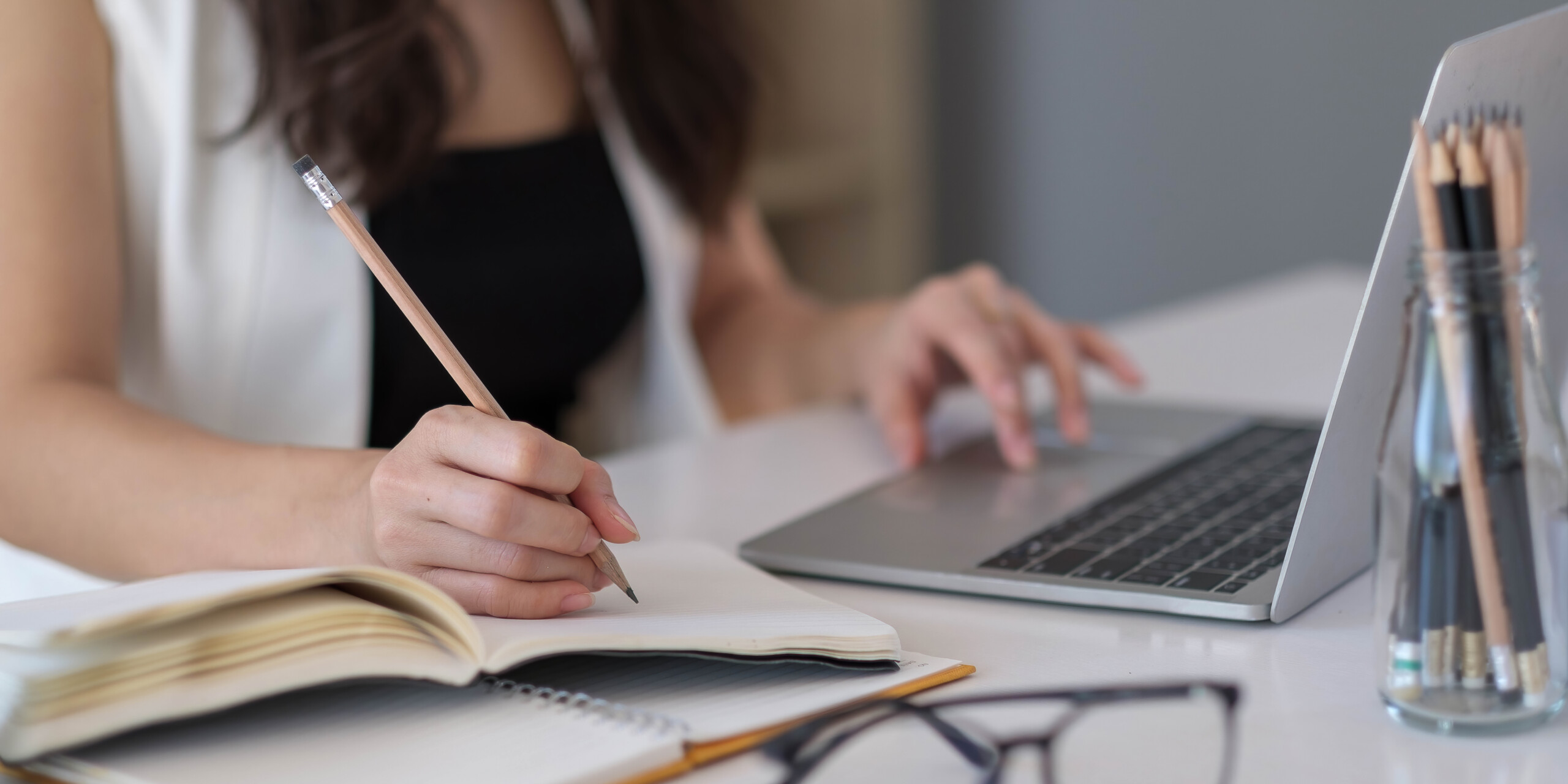 Closeup banner asian woman writing on notebook on table with lap